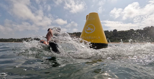 The correct technique to turn marker buoys in open water swimming